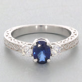 Blue Moissanite sterling silver ring with accent stones, showcasing elegant design and luxurious gemstone brilliance.